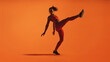 © Jacob Lund - Fit woman doing leg stretches on orange background