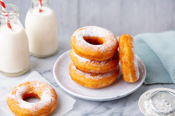 Canvas Print - Donuts with bottle of milk on marble table. Grey background. Close up.