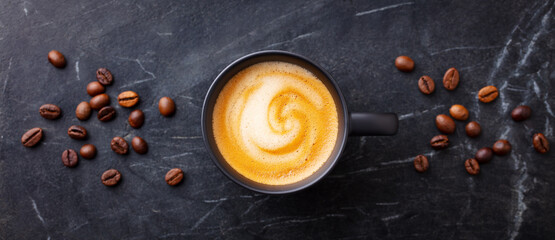 Canvas Print - Coffee espresso in cup on black marble background. Top view.