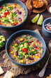 Vegetable quinoa soup, stew with avocado, corn, beans. South American traditional dish.