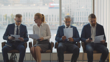 Elegant businesspeople come on appointment sitting in waiting room