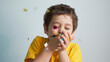 © yavdat - happy birthday child. Photo of charming cute fascinating nice little boy blowing confetti at you to show her festive mood with emotional face expression.