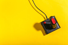 Old Joystick On Yellow Background With Shadow. Retro Gaming. Top View