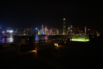 City landscape. Victoria Harbor and Hong Kong skyscrapers at night.