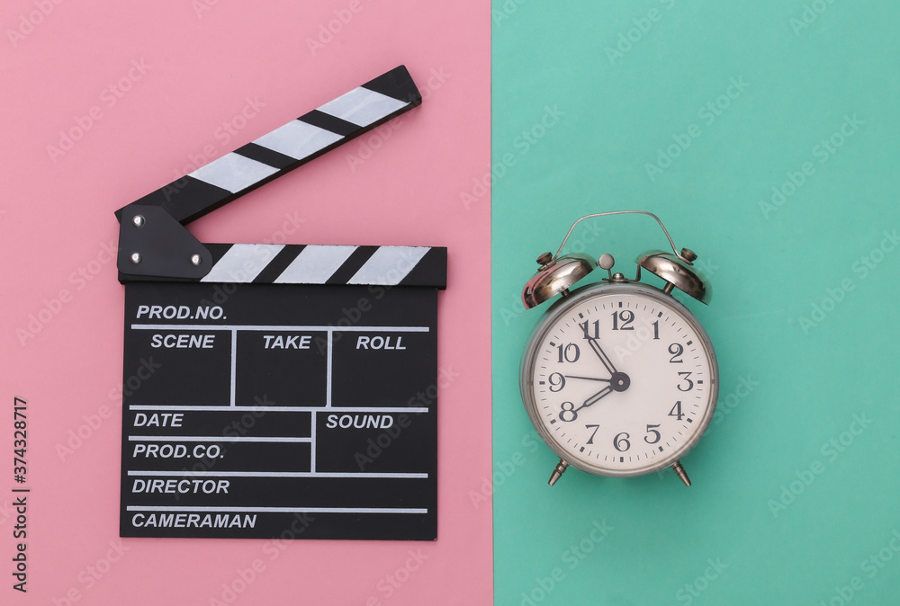 Clapper Clock Movie clapper board and alarm clock on a blue-pink pastel background ...