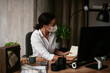 © JustLife - Beautiful businesswoman with medical mask working in office. Covid-19 concept.