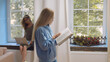 © nimito - Girl student reading book and walking in university common room