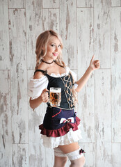 Wall Mural - Beautiful bavarian woman with beer in hands. Oktoberfest concept.