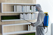 © Pornsak - Male medical staff wearing PPE uniforms to prevent COVID-19 from using a nebulizer. And use chemicals to disinfect at the library, reading room, to prevent the risk of coronavirus outbreak.