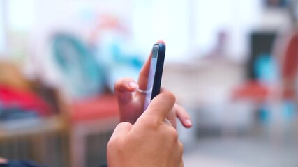 Poster - Close-up of the phone in the hands of a woman. Scroll the page on the screen with your fingers. Browse social networks in your spare time.