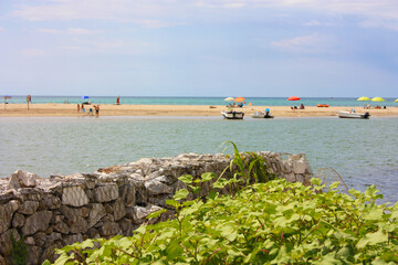 Wall Mural - glimpse of sea and river among the nature of marina di pisa in the tuscan serenity of the summer landscape