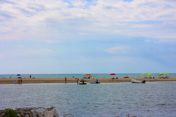 Wall Mural - glimpse of sea and river among the nature of marina di pisa in the tuscan serenity of the summer landscape