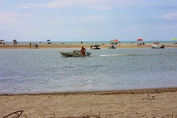 Wall Mural - glimpse of sea and river among the nature of marina di pisa in the tuscan serenity of the summer landscape