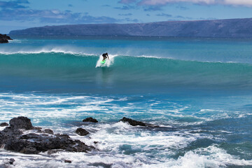 Wall Mural - Unrecognizable surfer on a big wave on Maui.