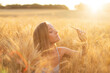 © alexkazachok - woman in wheat field at sunset