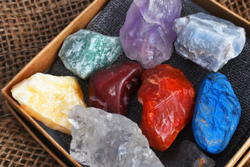 Wall Mural - A top view image of rough chakra crystals in a kit. 