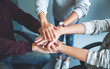 © Farknot Architect - Closeup image of business team standing and joining their hands together in office