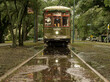 Old New Orleans streetcar reflected in rain puddle