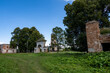 © константин константи - ruins of an old manor house among green trees against a blue sky