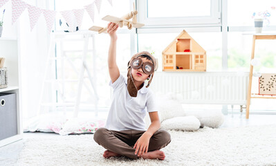 Wall Mural - Happy little boy playing with plane