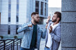 Two adult bearded men are fighting in the street. Conflict, bullying, robbery.