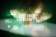 © ra2 studio - Finger touching tablet with charts and CUSTOMER ENGAGEMENT inscription, business concept