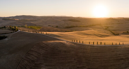 Wall Mural - aerial panorama of beautiful sunset over tuscan hills, farms, cypress lined roads