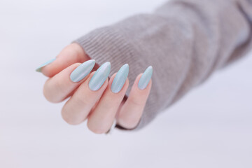 Female hands with long nails with blue nail polish