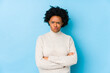 © Asier - Middle aged african american woman against a blue background isolated frowning face in displeasure, keeps arms folded.