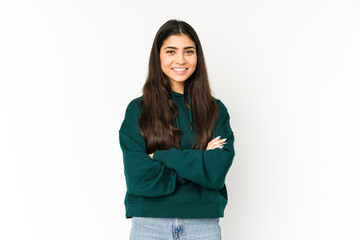 young indian woman isolated on purple background who feels confident, crossing arms with determinati