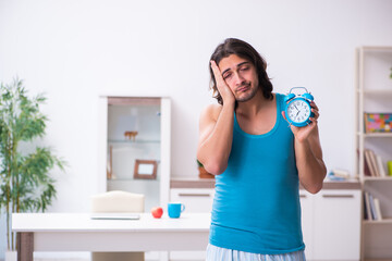 Wall Mural - Young man waking up at home