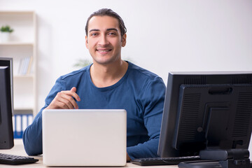 Young male it specialist working in the office