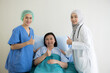 © amenic181 - Asian female doctors and his female patient with thump up in bed at hospital