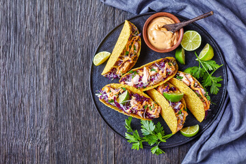 Wall Mural - salmon corn tacos on a black plate
