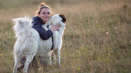 Canvas Print - happy woman with white dog in autumn landscape