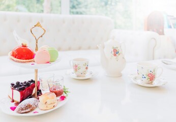 Tea set and cake Placed on a white marble table in a white room background.