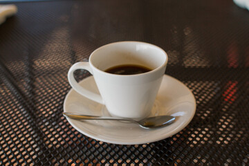 a cup of coffee on the table in a coffee shop