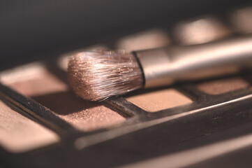 Wall Mural - Make up brush on eye shadow palette closeup. Selective focus.