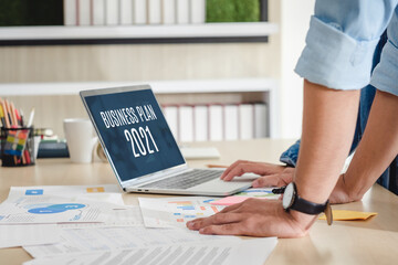 Poster - close up hand creative designer team casual meeting and brainstorming business plan with paperwork and online data on laptop in meeting room at modern office