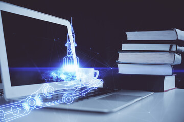 Desktop computer background in office and start up theme hologram drawing. Double exposure. Startup concept.