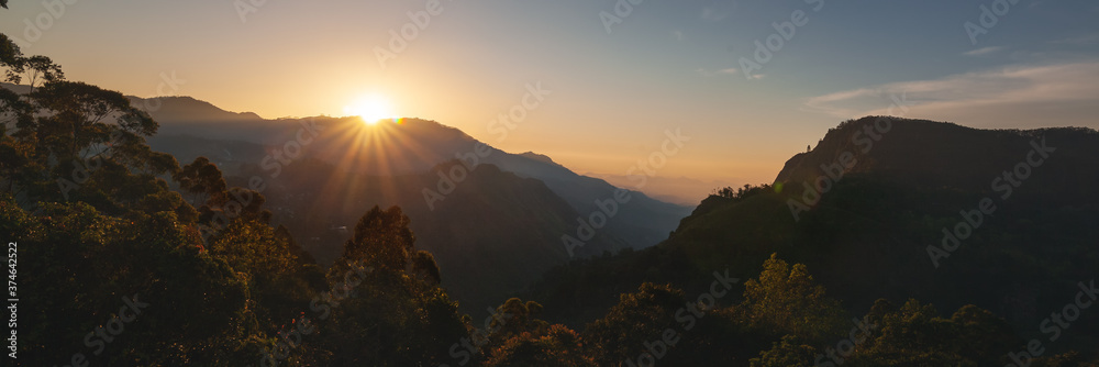 Bright beautiful landscape, sunset sky and rays of the sun over mountains. Panorama banner format - obrazy, fototapety, plakaty 
