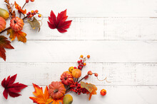 Festive Autumn Decor From Pumpkins, Berries And Leaves On A White  Wooden Background. Concept Of Thanksgiving Day Or Halloween. Flat Lay Autumn Composition With Copy Space.