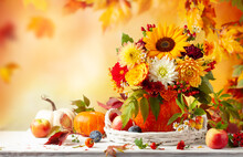 Autumn Bouquet Of Beautiful Flowers And Berries In A Pumpkin On Wooden White Table. Concept Of Autumn Festive Decoration For Thanksgiving Day.