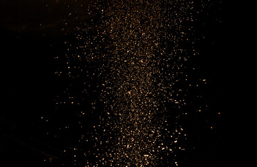 Leinwandbilder - Gold dust (shavings, aerosol) on a black background