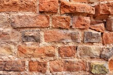 Destroyed Red Bricks Wall. Grunge Textured Background. Vintage Facade. Broken Wall