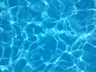  Blue water of a swimming pool in summer with reflections of sunlight in rippling waves