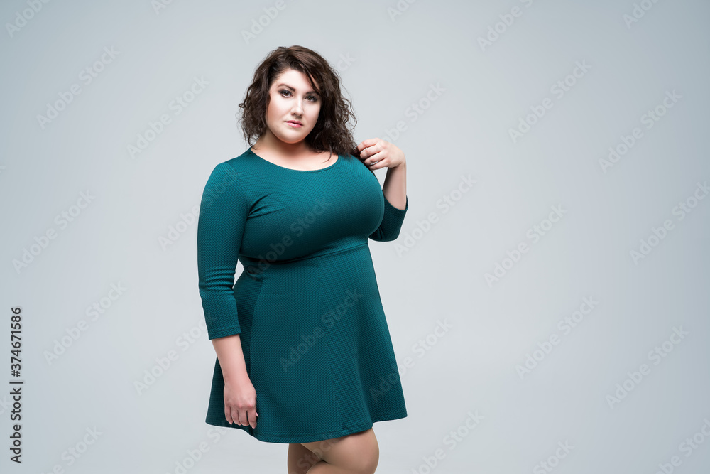 Plus size fashion model in green dress, fat woman on gray background, body positive concept Stock Photo | Adobe Stock Plus size fashion model in green dress, fat woman on gray background, body positive concept Stock Photo | Adobe Stock