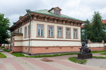 Wall Mural - Old wooden building in a provincial town