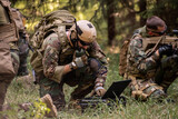 Busy soldier with backpack using military laptop while passing information through radio device in forest