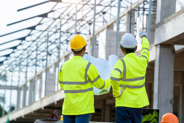 Aufkleber - Structural engineer and architect dressed in green work vests work in progress of construction project at construction site.